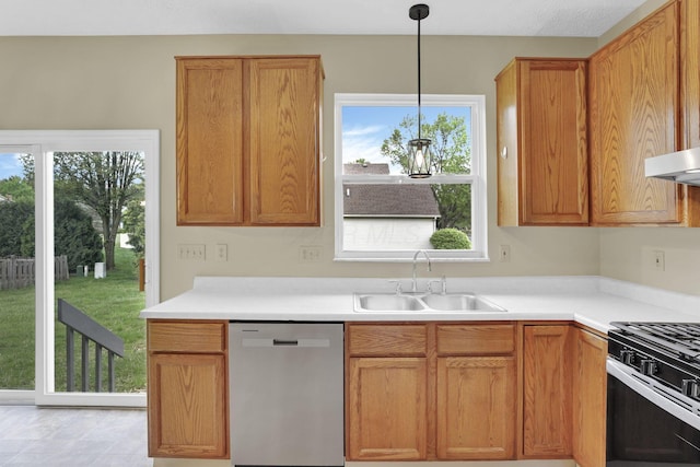 kitchen with pendant lighting, stainless steel dishwasher, a healthy amount of sunlight, and a sink