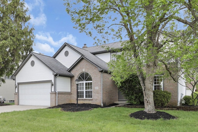 traditional home featuring brick siding, concrete driveway, a garage, a front yard, and a chimney