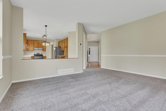 unfurnished living room featuring visible vents, baseboards, and light carpet