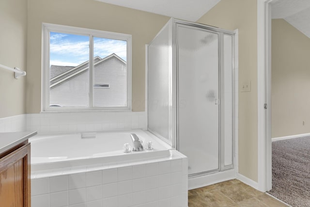 bathroom with a bath, vanity, and a stall shower