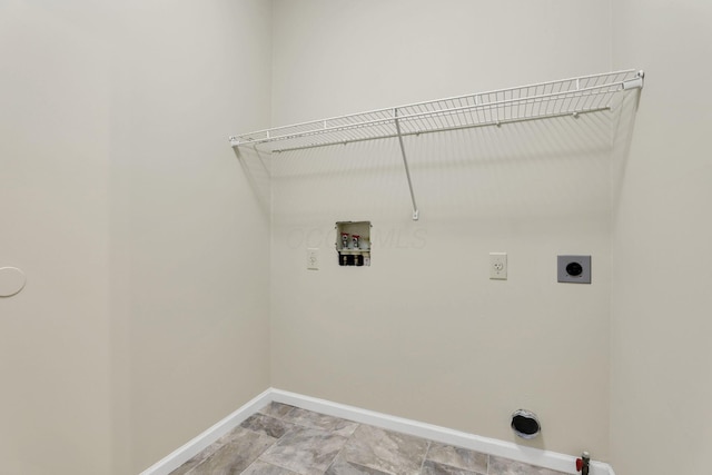 washroom with laundry area, hookup for an electric dryer, hookup for a gas dryer, washer hookup, and baseboards