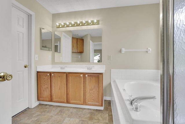 bathroom featuring baseboards, a sink, double vanity, and a bath