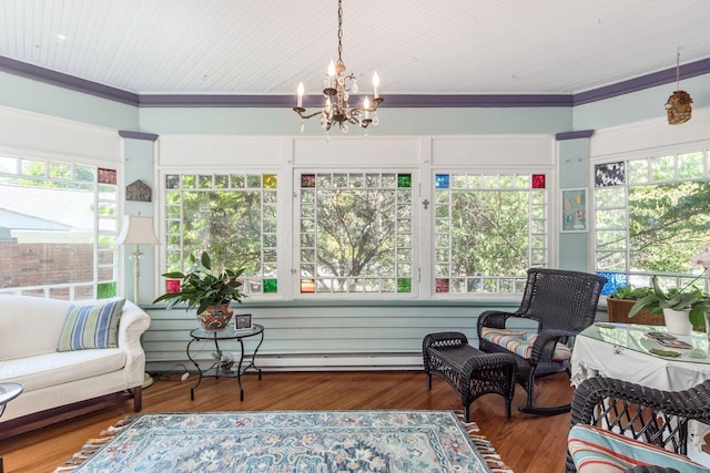 sunroom / solarium featuring crown molding, a baseboard radiator, wood finished floors, and a chandelier