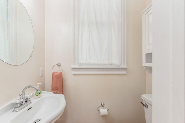 bathroom with toilet and a sink