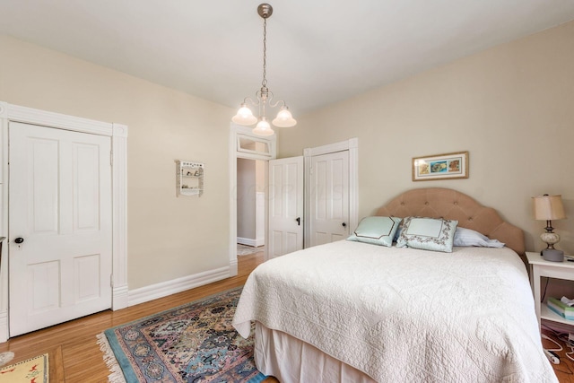 bedroom featuring baseboards, a closet, and wood finished floors