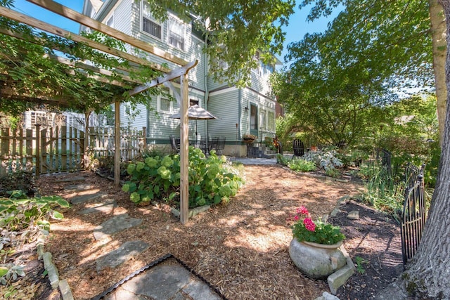 view of yard with a pergola and fence