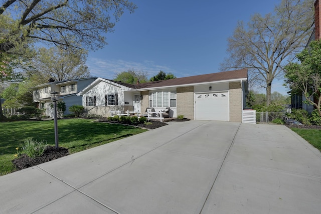 ranch-style home featuring brick siding, a garage, a front yard, and concrete driveway