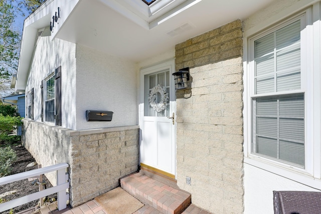 entrance to property with stucco siding