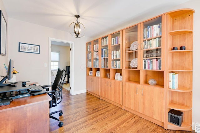 office area featuring visible vents, light wood-style flooring, baseboards, and a notable chandelier