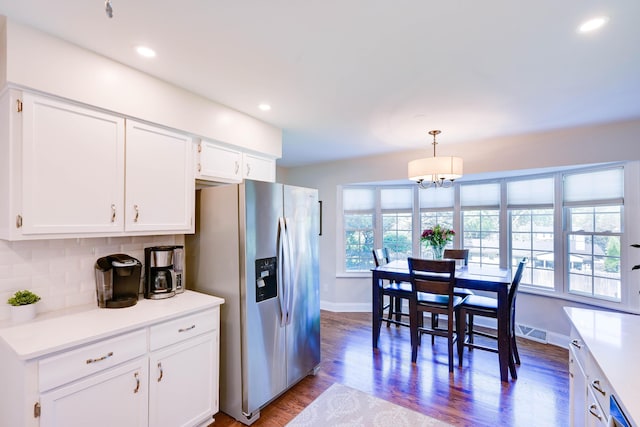 kitchen featuring an inviting chandelier, stainless steel fridge with ice dispenser, baseboards, and white cabinets