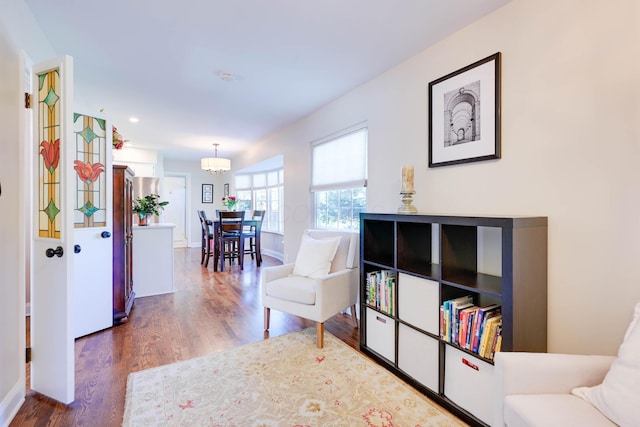 sitting room with baseboards, recessed lighting, and wood finished floors