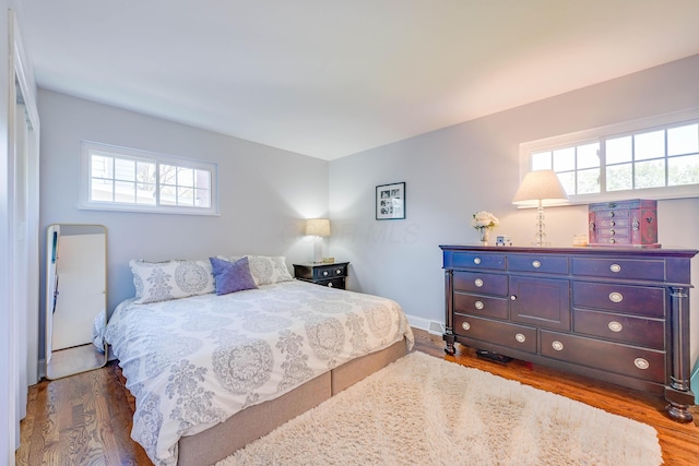 bedroom featuring baseboards and dark wood-type flooring