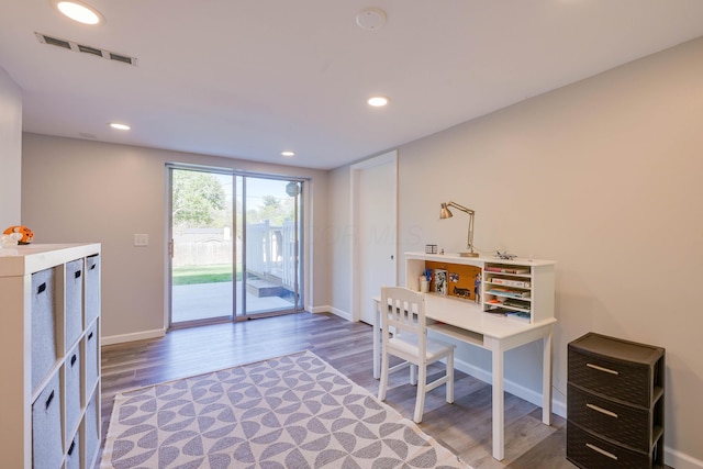 office space with baseboards, recessed lighting, wood finished floors, and visible vents