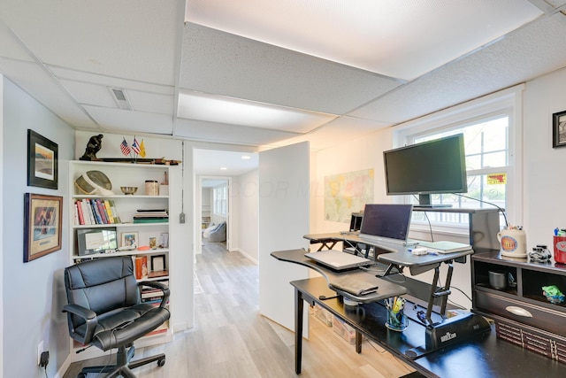 office with visible vents, a drop ceiling, and wood finished floors