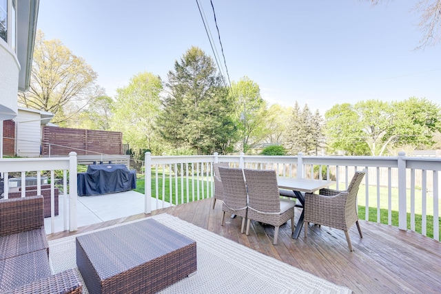 deck featuring a yard and outdoor dining space