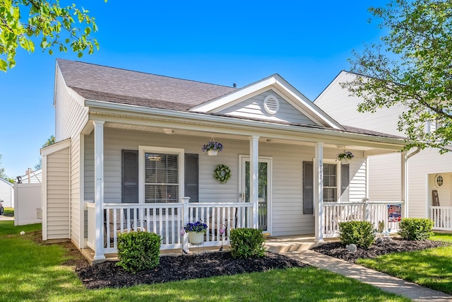 bungalow-style house featuring roof with shingles and covered porch