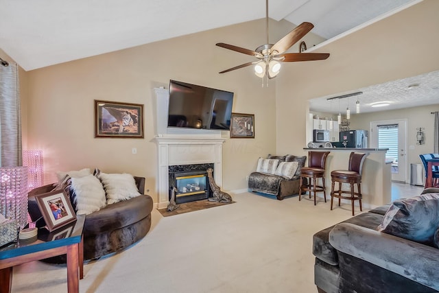 carpeted living room featuring high vaulted ceiling, a fireplace, and a ceiling fan