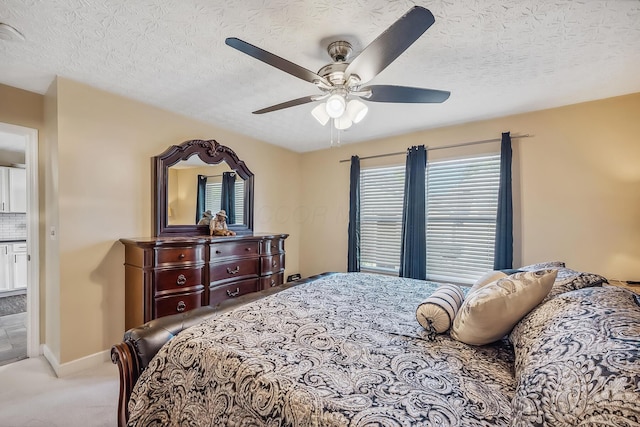 bedroom with baseboards, carpet flooring, a textured ceiling, and a ceiling fan