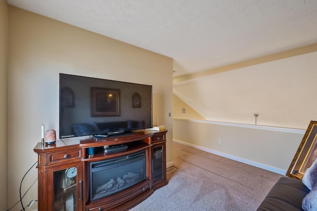 carpeted office with baseboards, a textured ceiling, and lofted ceiling