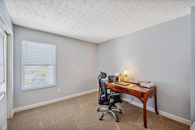 carpeted home office with baseboards
