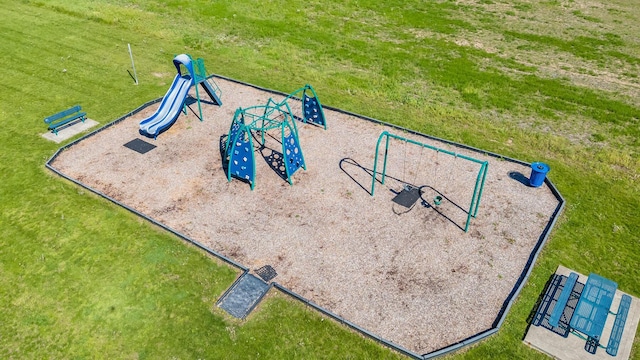 view of property's community with a lawn and playground community