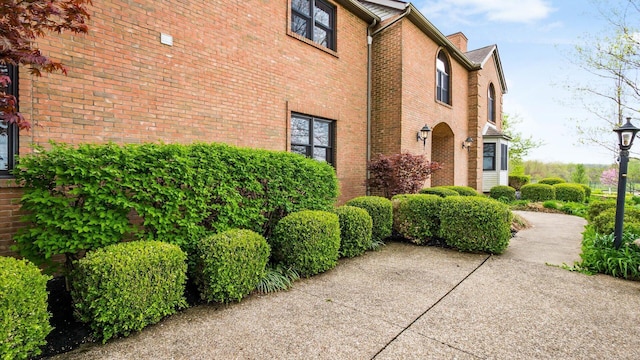 view of side of home featuring brick siding