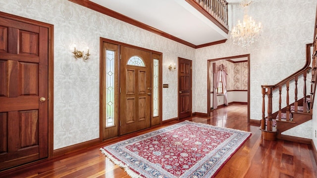 foyer featuring stairs, wallpapered walls, baseboards, and hardwood / wood-style floors