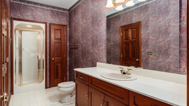 full bath featuring vanity, tile patterned floors, a stall shower, and toilet