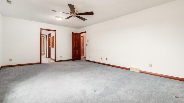 empty room featuring baseboards, a ceiling fan, carpet flooring, and visible vents