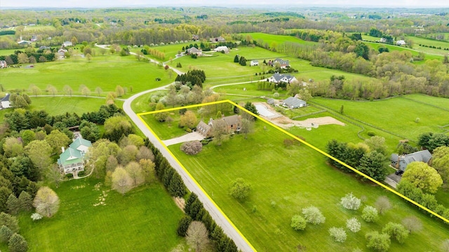 birds eye view of property with a rural view