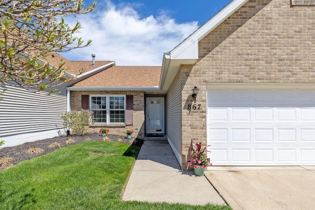 867 Red Oak Trl, Mansfield, OH 44904 - doorway to property with a lawn, brick siding, roof with shingles, and a garage