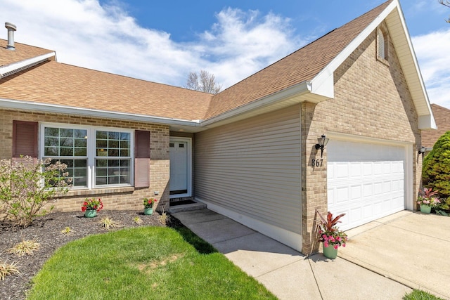 867 Red Oak Trl, Mansfield, OH 44904 - entrance to property featuring a garage, concrete driveway, roof with shingles, and brick siding
