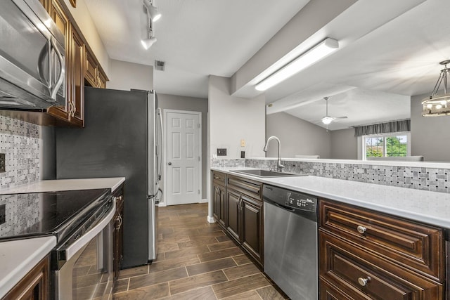 867 Red Oak Trl, Mansfield, OH 44904 - kitchen with light countertops, a sink, tasteful backsplash, and stainless steel appliances