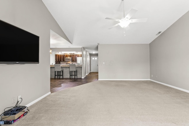 867 Red Oak Trl, Mansfield, OH 44904 - unfurnished living room with a ceiling fan, baseboards, vaulted ceiling, and dark colored carpet