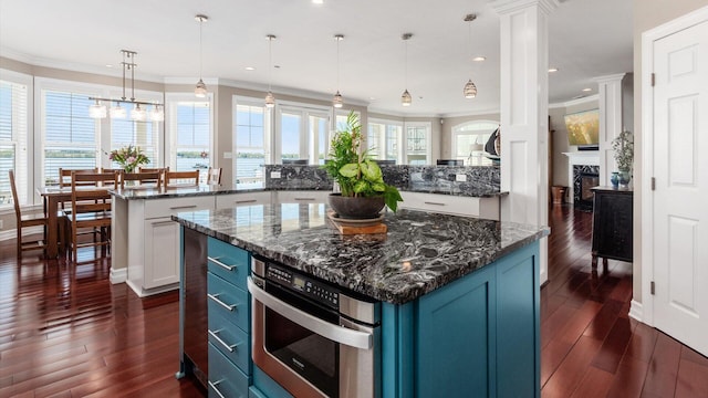 3555 Sellers Dr NE, Millersport, OH 43046 - kitchen featuring a kitchen island, decorative columns, oven, dark wood finished floors, and recessed lighting