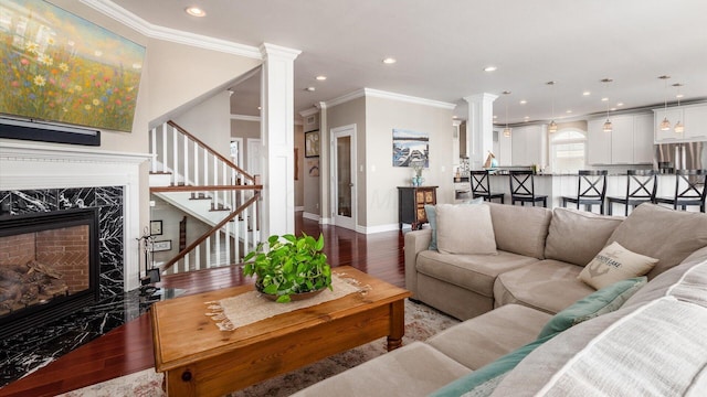 3555 Sellers Dr NE, Millersport, OH 43046 - living area with hardwood / wood-style flooring, a high end fireplace, stairs, ornate columns, and baseboards