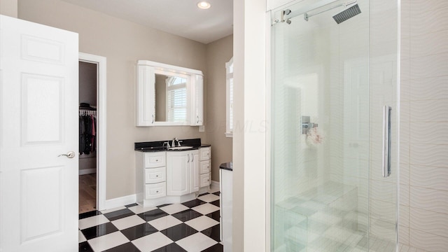 3555 Sellers Dr NE, Millersport, OH 43046 - bathroom with vanity, a stall shower, baseboards, a spacious closet, and tile patterned floors