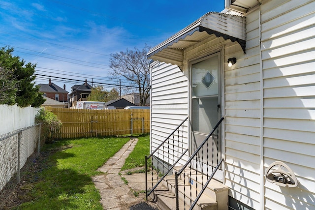 exterior space with a fenced backyard and entry steps