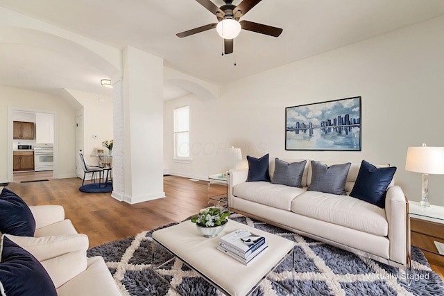 1361 City Park Ave, Columbus, OH 43207 - living area with arched walkways, a ceiling fan, and wood finished floors