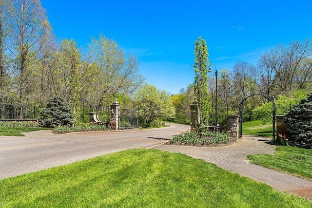 surrounding community featuring a gate, a yard, and driveway
