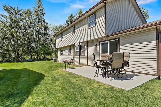 back of house with a patio area and a yard