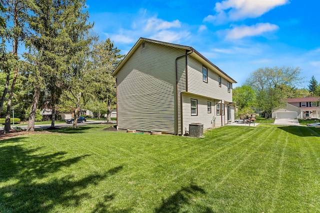 view of side of property featuring a lawn and central air condition unit
