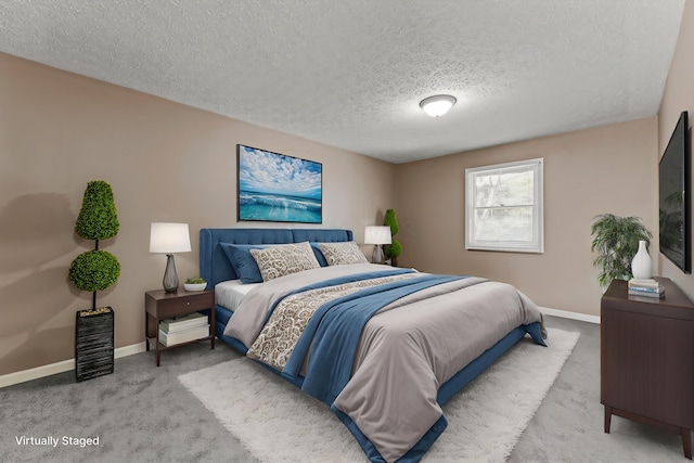 carpeted bedroom with baseboards and a textured ceiling