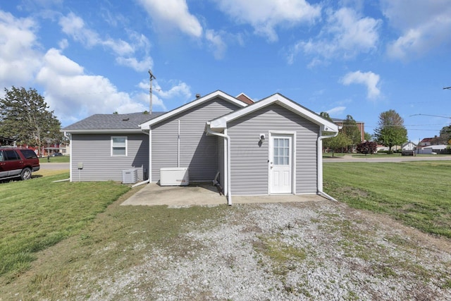 rear view of property featuring a lawn
