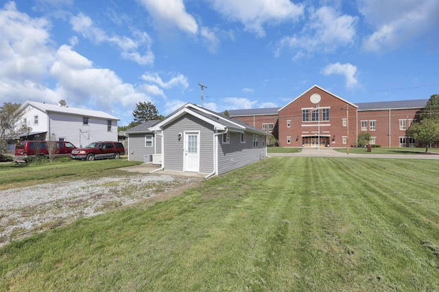 rear view of house with a yard