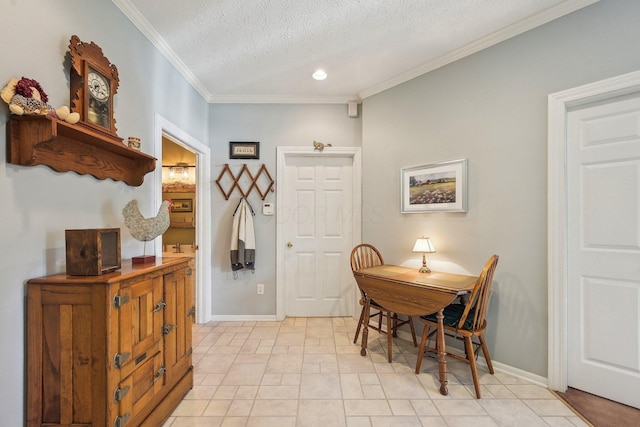 dining space with baseboards, ornamental molding, a textured ceiling, and recessed lighting