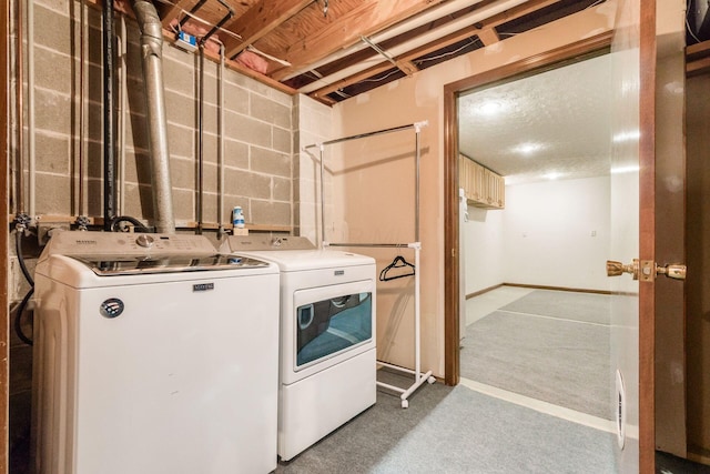 laundry room featuring baseboards, laundry area, washing machine and dryer, and carpet flooring