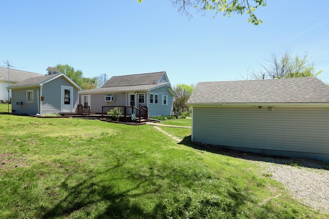rear view of property with a lawn and a wooden deck