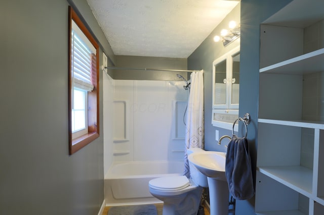 full bath featuring toilet, a textured ceiling, and shower / tub combo with curtain