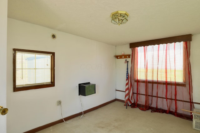 unfurnished room with baseboards and carpet flooring